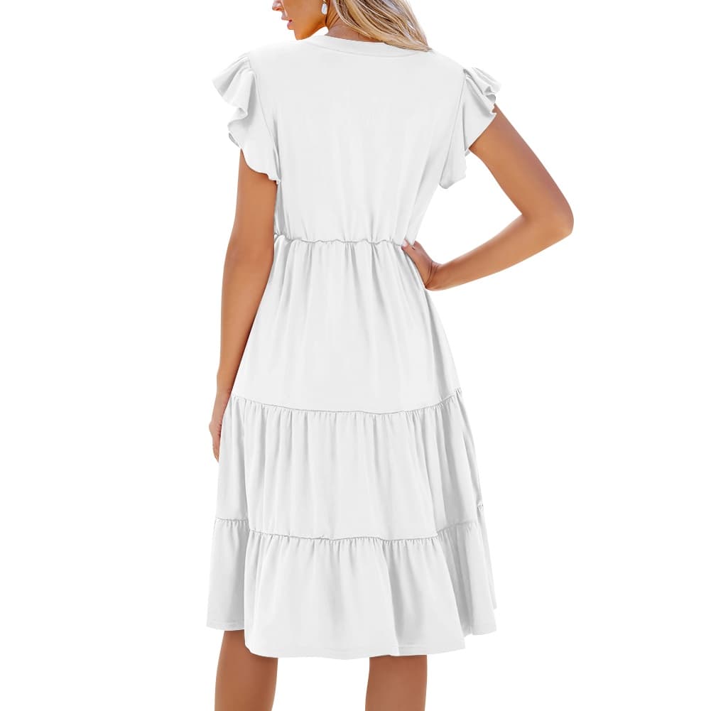 une femme qui porte de dos une robe midi patchwork femme col v coloris blanc manches courtes